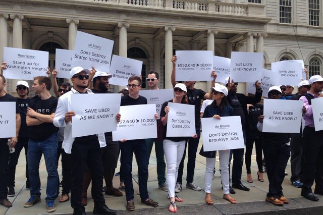 A mix of Uber employees and drivers rallying outside of City Hall this afternoon